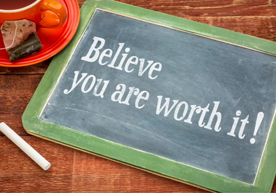 A chalkboard with the words 'Believe you are worth it!' written on it. The image represents the importance of setting boundaries in various aspects of life, including relationships, self-care, and professional responsibilities. Believing you are worth it is essential for setting boundaries, as it empowers you to prioritise your needs and well-being.